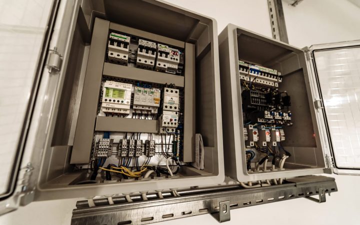 A close-up view of a commercial electrical panel with organized wiring and circuit breakers, showcasing professional electrical infrastructure.