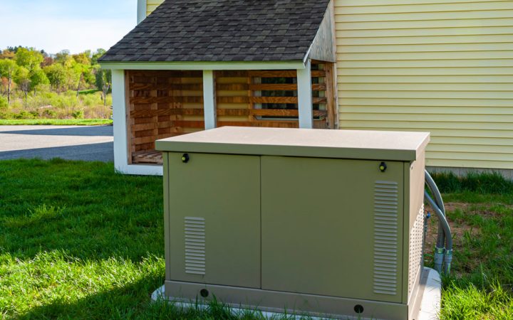A compact residential backup generator installed outdoors, providing reliable power solutions for homes.